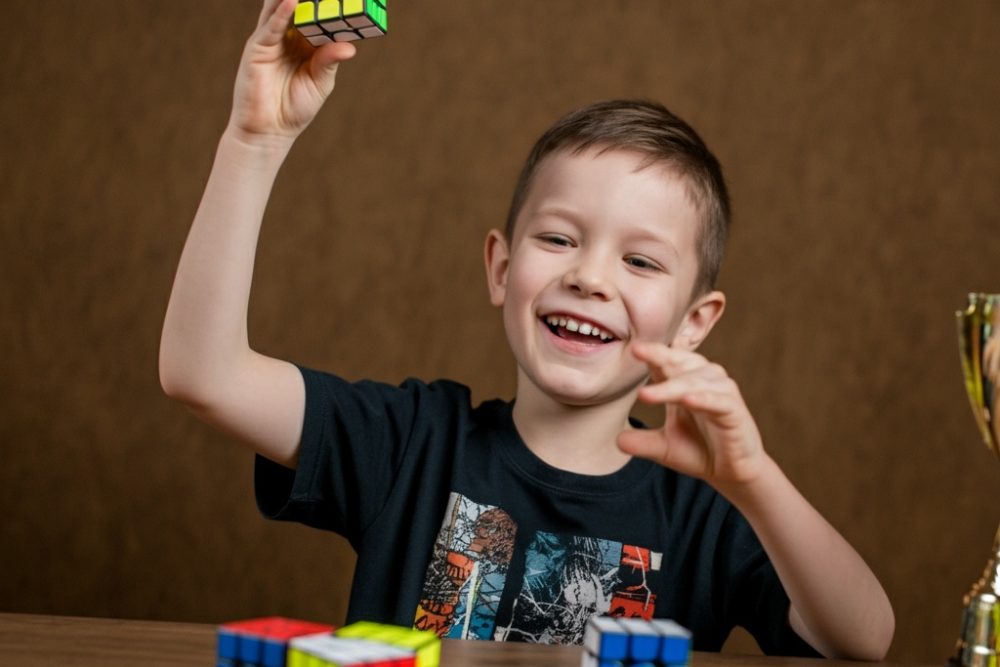 Child,Solved,Rubik,Cube,Celebrating,Trophy